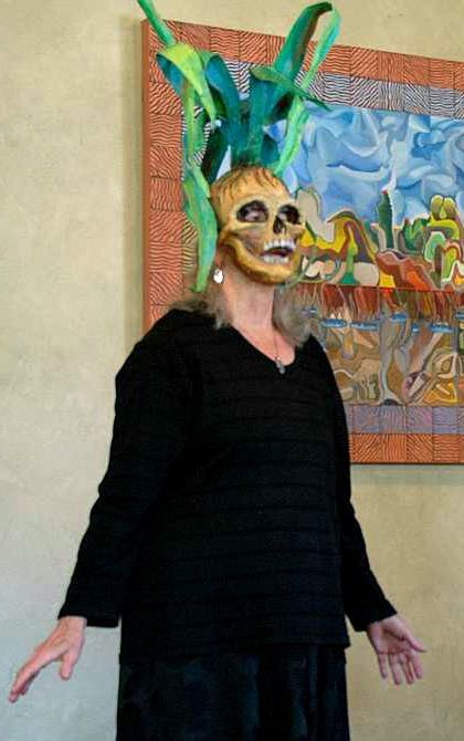 Jenny Badger Sultan in a skull mask from which corn stalks grow; at The Dream Institute, Berkeley CA.